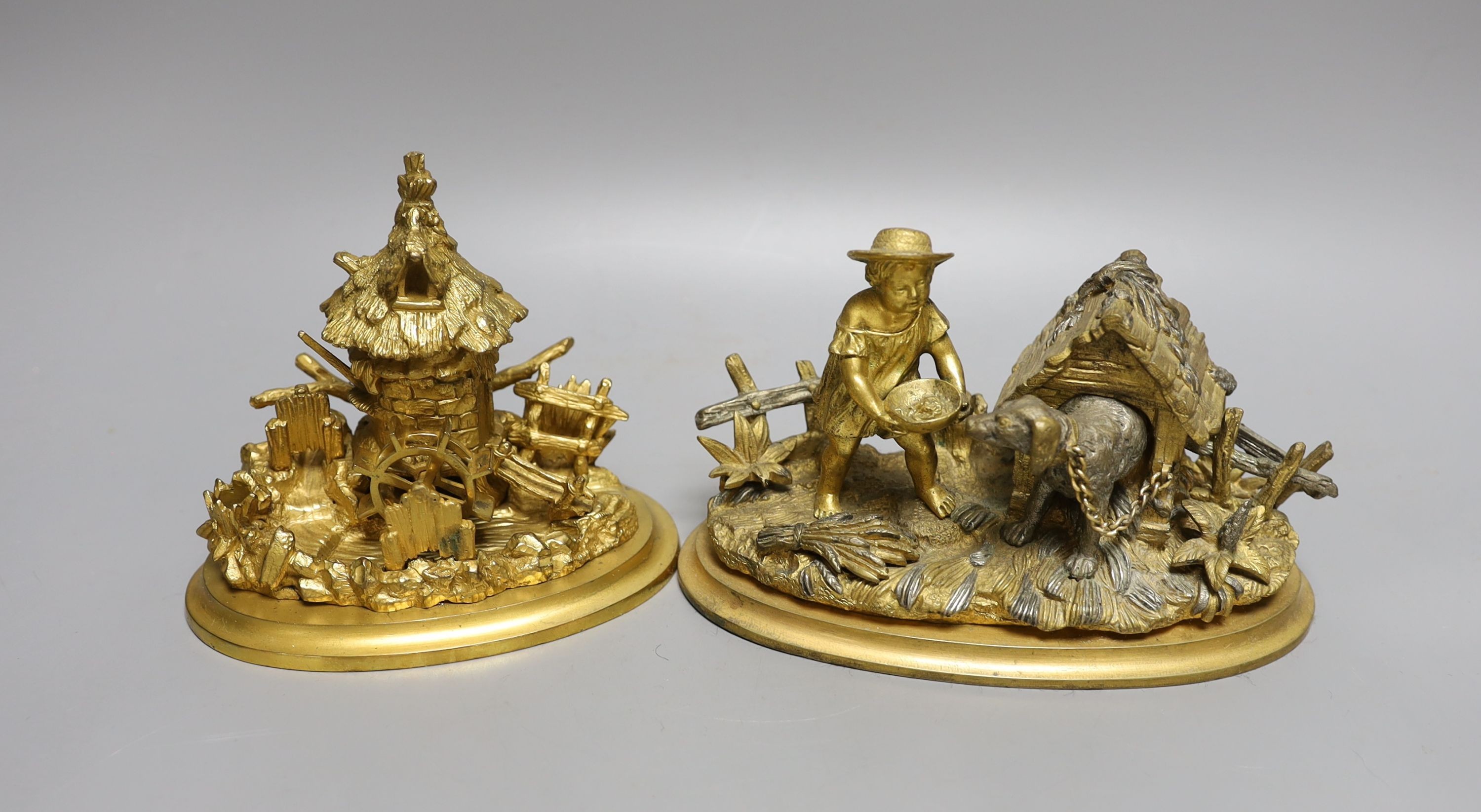 Two 19th century ormolu inkwells, modelled as a dog in a kennel, a water mill together with a chamberstick